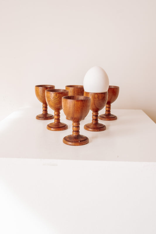 Set of 6 wooden egg cups on a high base
