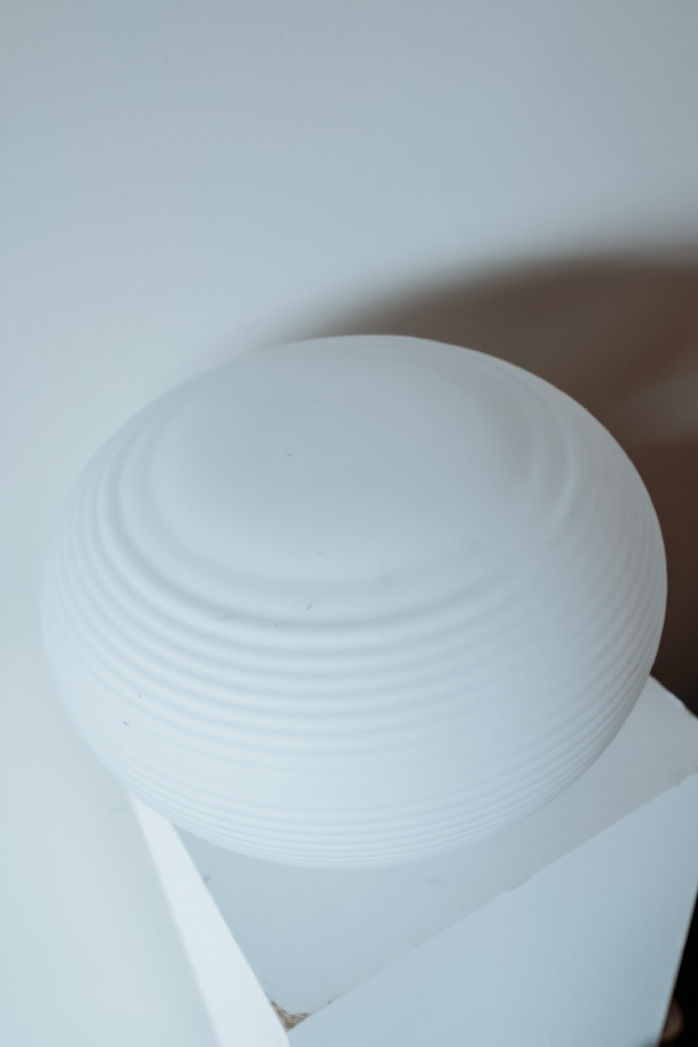 Ronde glazen tafellamp van wit geribbeld melkglas