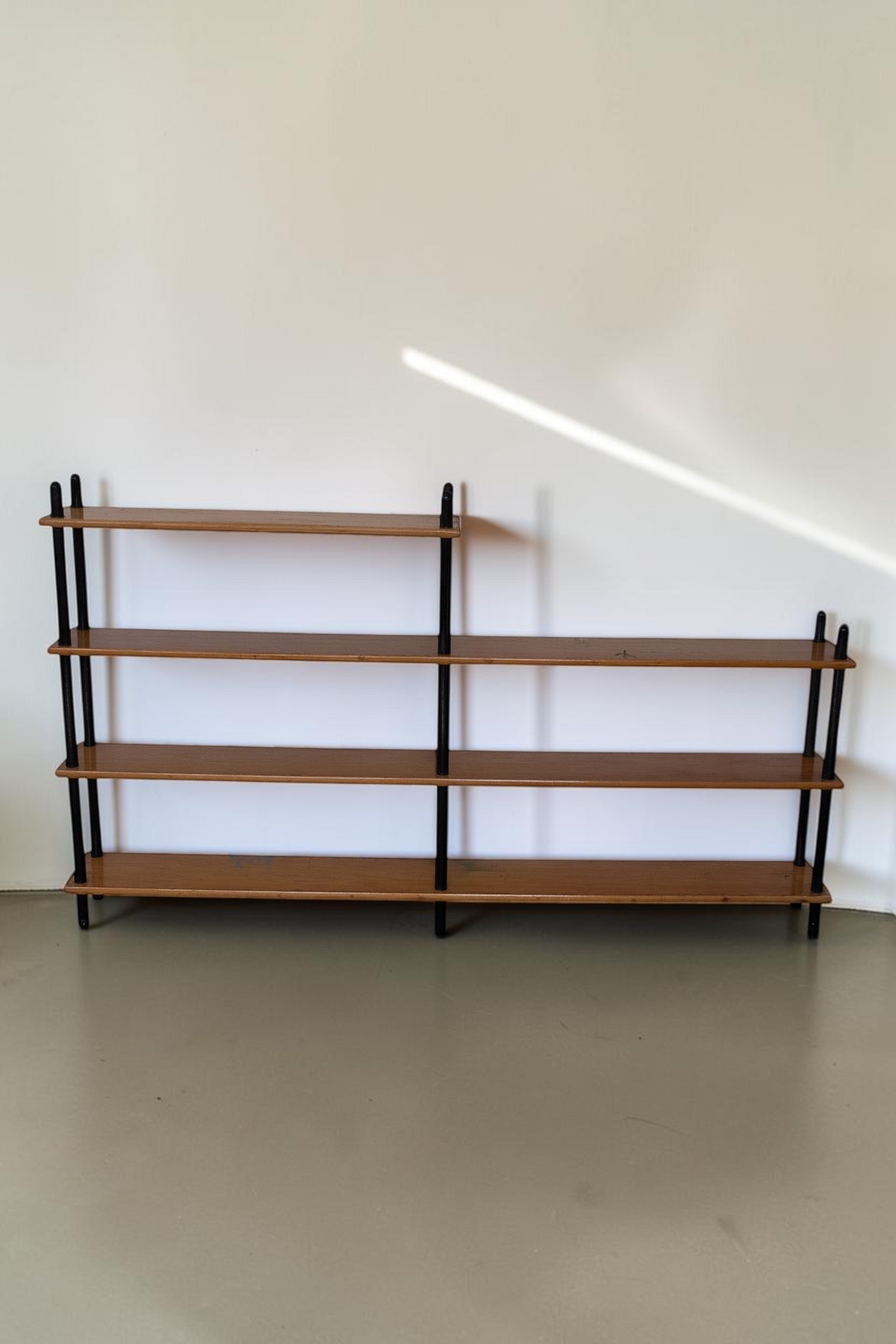 tessvintage 1960s mid-century modern wooden shelving unit with black lacquered poles and four tiered shelves