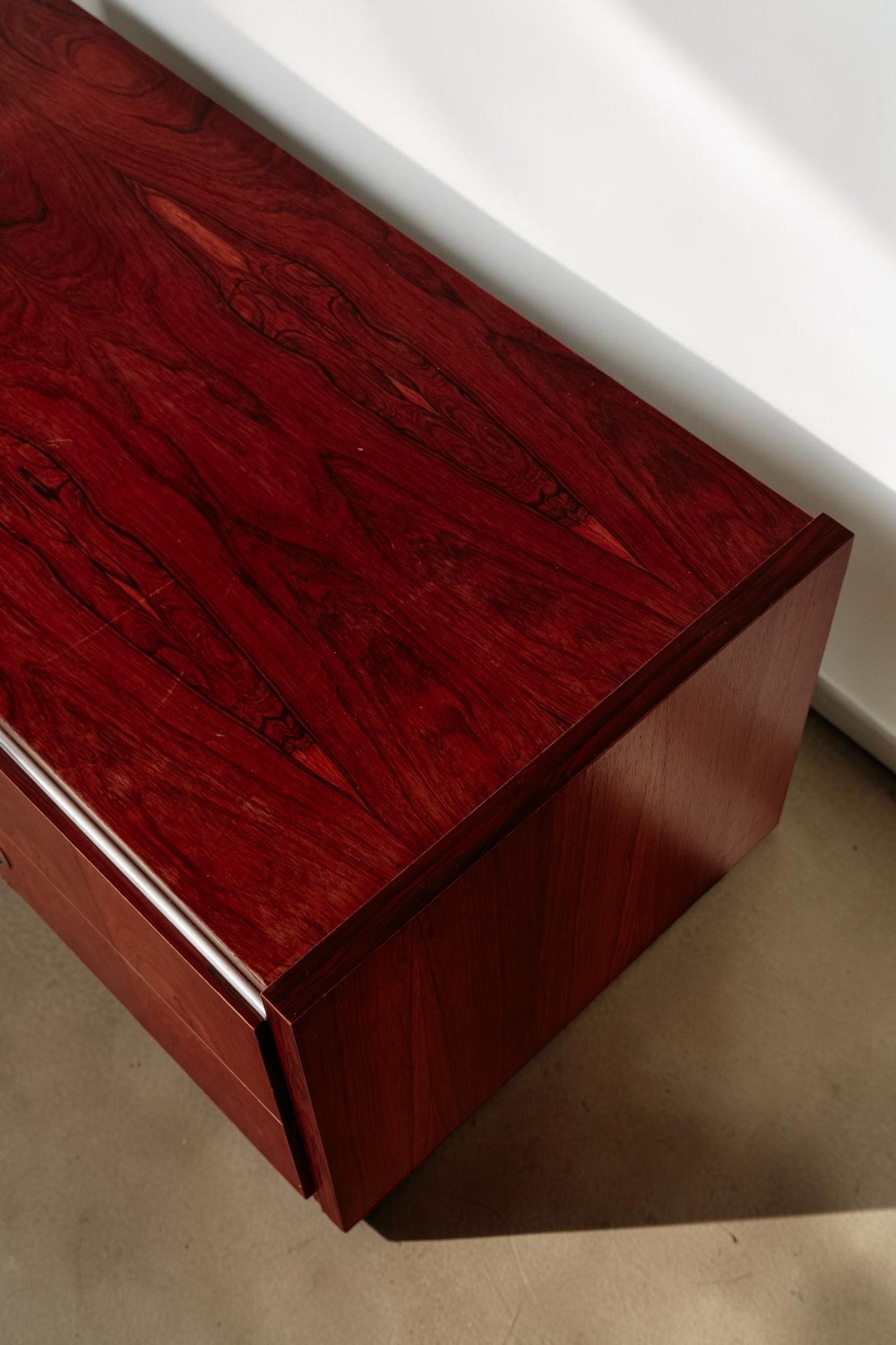 tessvintage 1960s sideboard in rich red-brown rosewood veneer with distinctive wood grain and chrome accents