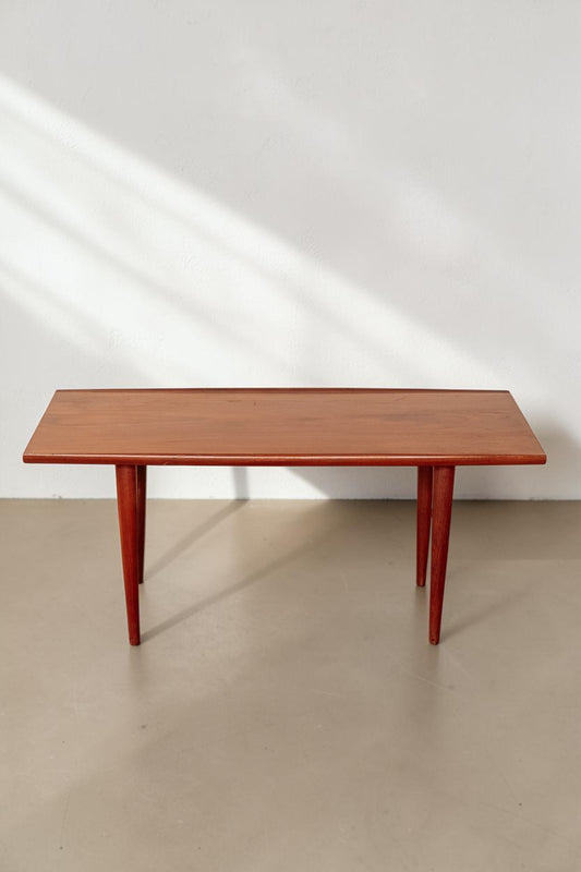 tessvintage mid-century modern teak coffee table with rounded edges and tapered legs in a warm wood finish