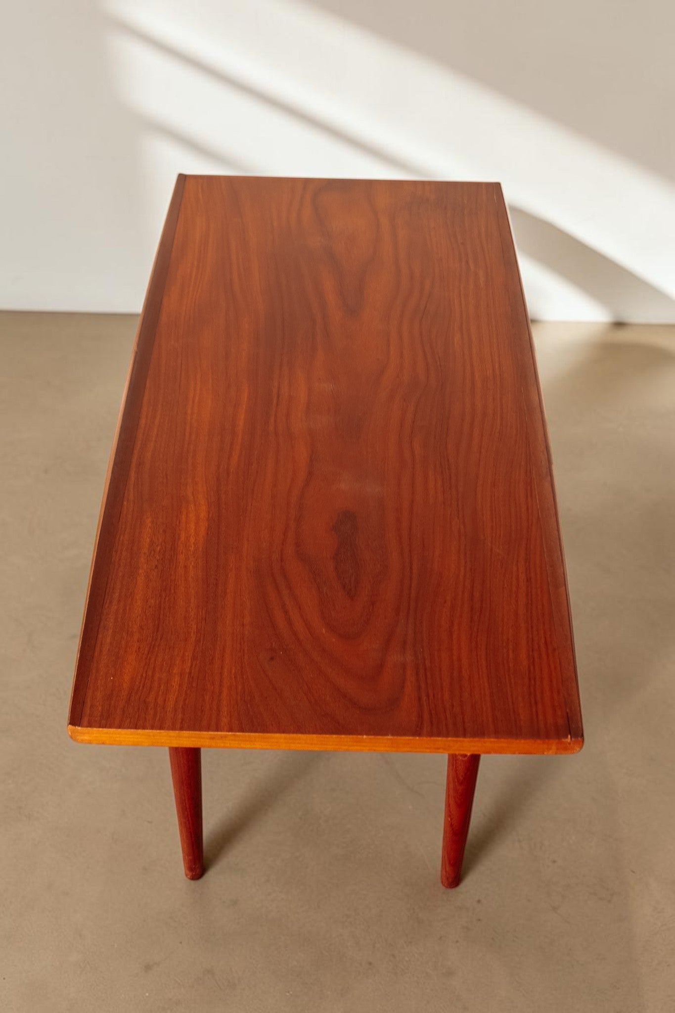 tessvintage mid century modern teak coffee table with rounded edges and tapered legs, top view